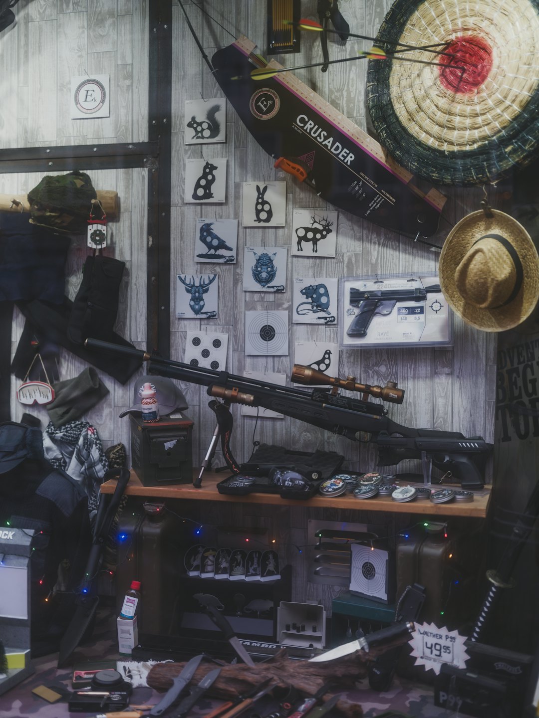 Hunting and outdoor gear displayed on a wooden shelf.